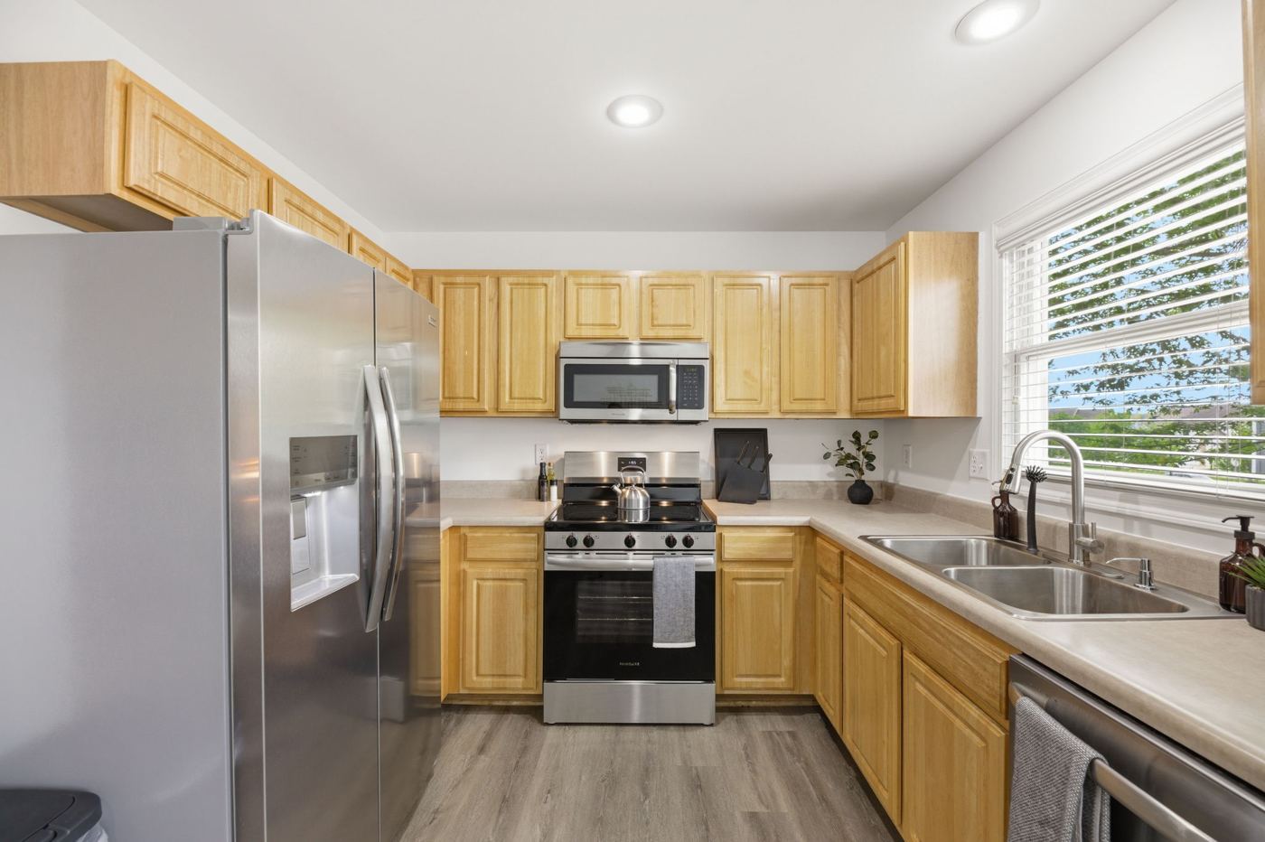Kitchen with stainless steel refrigerator, microwave and gas range