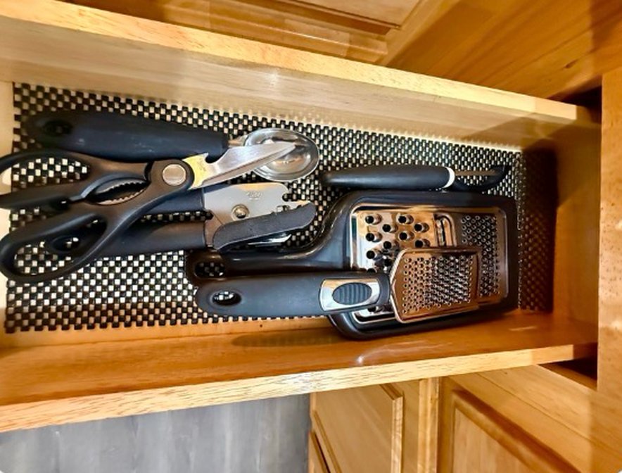 Drawer with scissors, can opener and grater