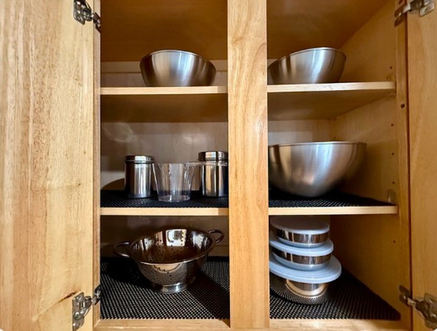Cabinet with mixing bowls, colander and food storage