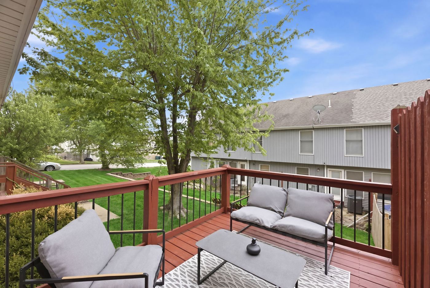 Balcony view of the yard and trees