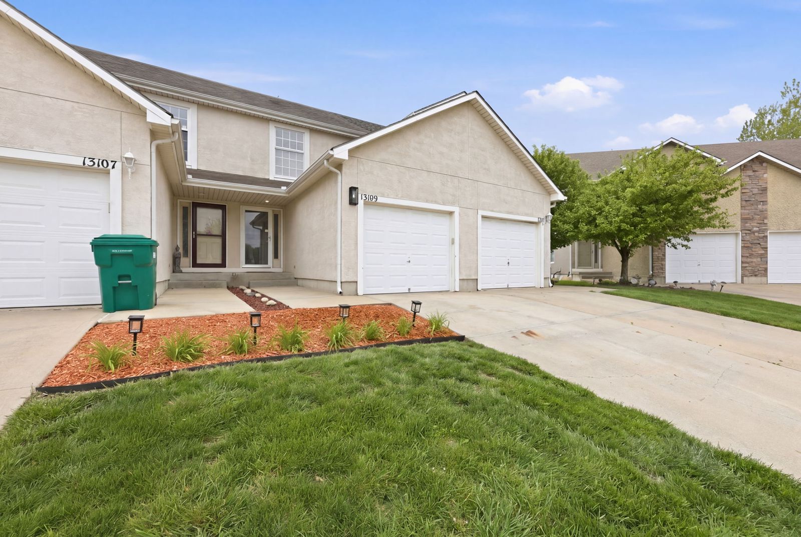 Front of The Legends Landing with garage and driveway